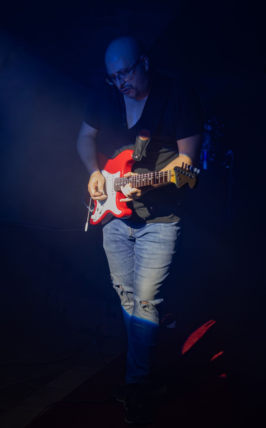 Daniel Retzl spielt rote Stratocaster im Bühnenlicht